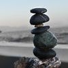 Stones balancing on top of one another on a beach